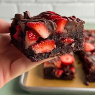 Chocolate covered strawberry brownies topped with fresh strawberries