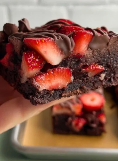 Chocolate covered strawberry brownies topped with fresh strawberries