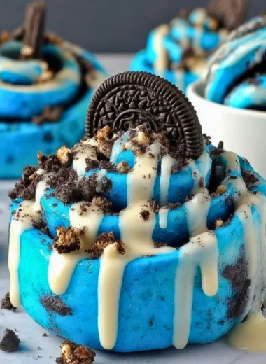 Delicious Cookie Monster Cinnamon Rolls with blue swirl icing