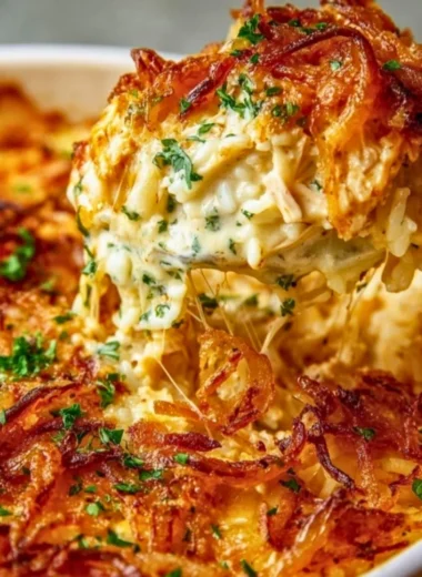 Creamy French Onion Chicken Rice served in a bowl with herbs on top.