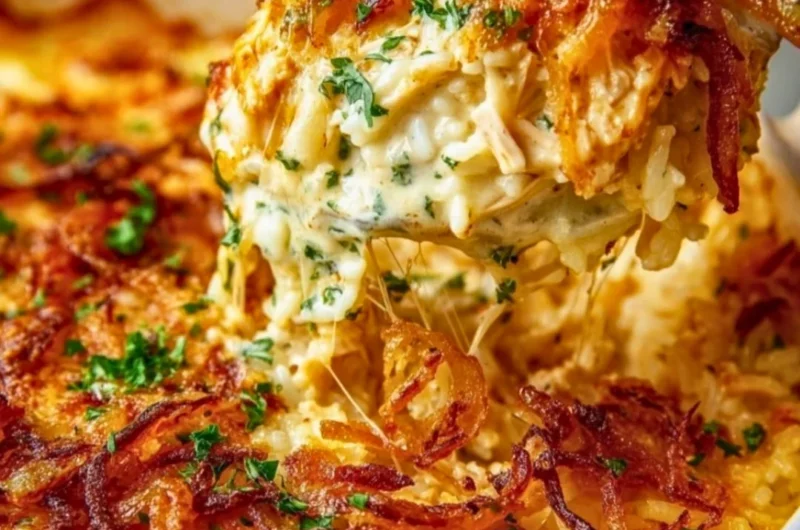 Creamy French Onion Chicken Rice served in a bowl with herbs on top.