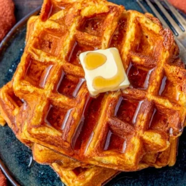 Delicious French Toast Waffles topped with syrup and berries