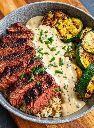 Grilled steak bowl with sauce and grilled zucchini served in a bowl