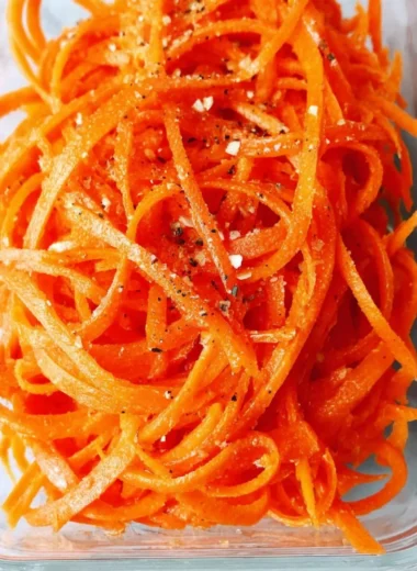 Fresh raw carrot salad with colorful vegetables and dressing