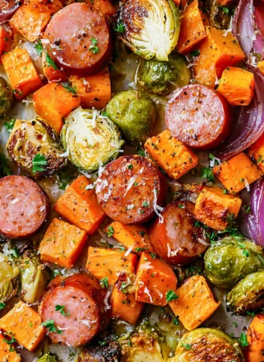 Sheet-pan sausage with vibrant fall vegetables ready to bake.