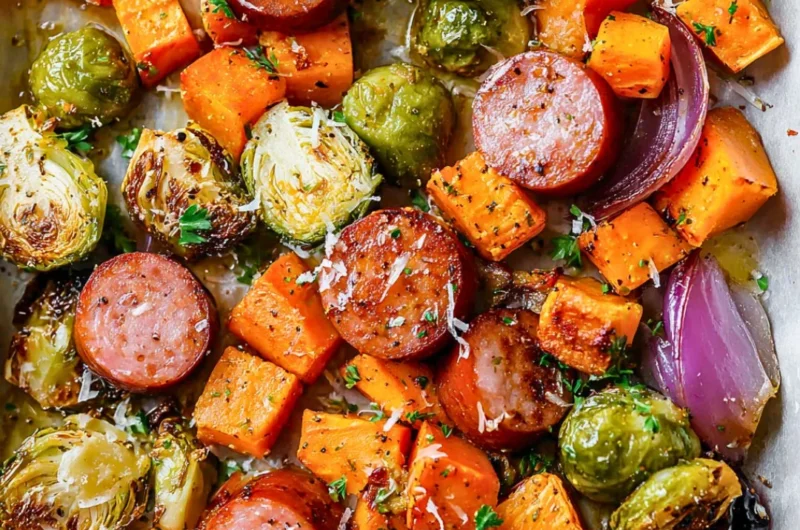 Sheet-pan sausage with vibrant fall vegetables ready to bake.