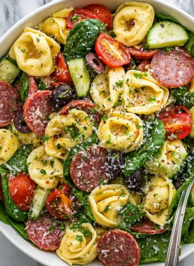 Colorful tortellini pasta salad served in a bowl with fresh vegetables