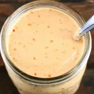 Bottle of Boom Sauce, a flavorful seasoning for enhancing dishes.