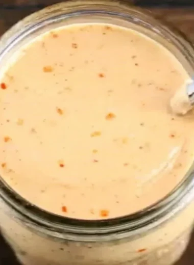 Bottle of Boom Sauce, a flavorful seasoning for enhancing dishes.