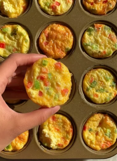 Delicious breakfast egg muffins served on a plate with herbs and vegetables.