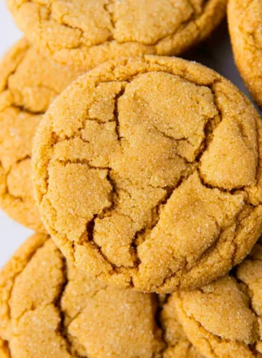 Chewy brown sugar cookies stacked on a plate, showcasing their soft texture.