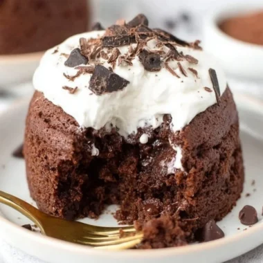 Delicious chocolate banana mug cake topped with chocolate chips in a white mug
