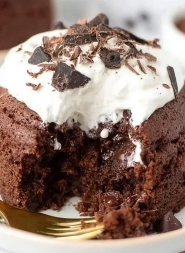 Delicious chocolate banana mug cake topped with chocolate chips in a white mug