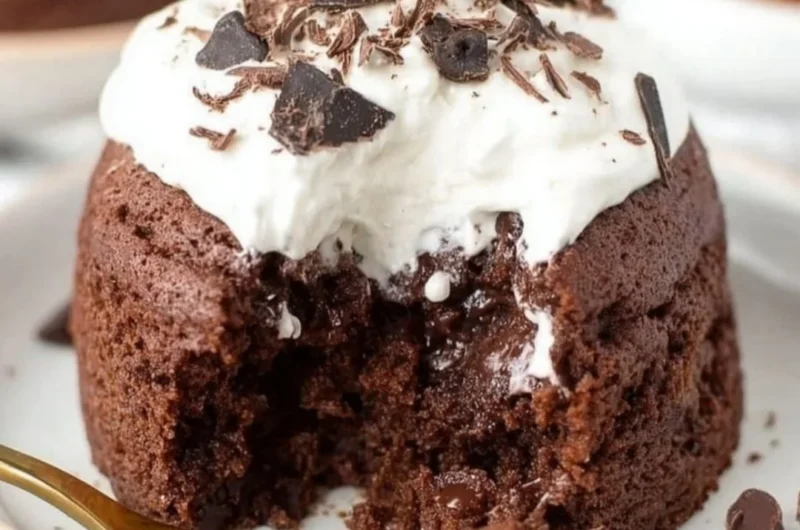 Delicious chocolate banana mug cake topped with chocolate chips in a white mug