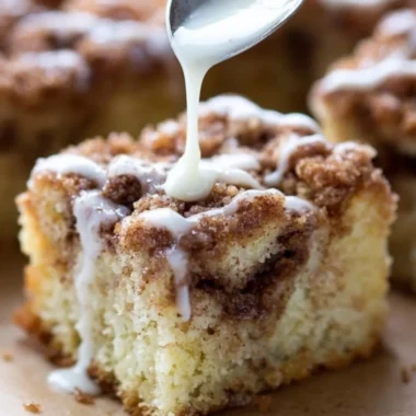 Delicious homemade coffee cake with a crumb topping, served on a plate.