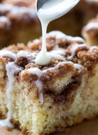 Delicious homemade coffee cake with a crumb topping, served on a plate.