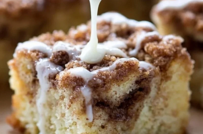 Delicious homemade coffee cake with a crumb topping, served on a plate.