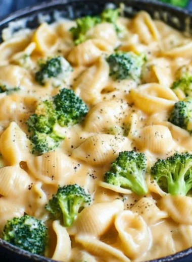 Creamy broccoli mac and cheese dish with cheesy sauce and fresh broccoli