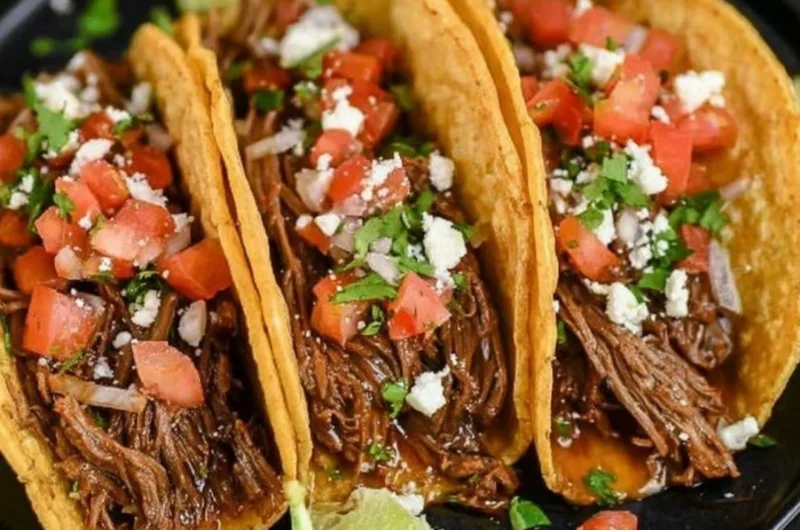 Delicious Crock Pot street tacos served in warm tortillas with fresh toppings