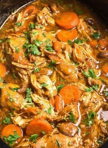 Delicious crockpot chicken thigh pot roast with vegetables and herbs.