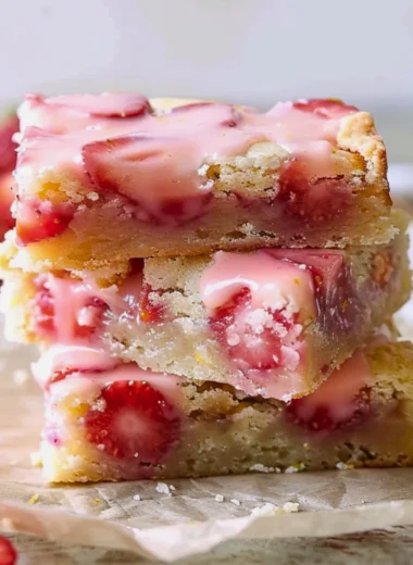 Delicious easy strawberry lemon blondies topped with fresh strawberries and lemon zest.