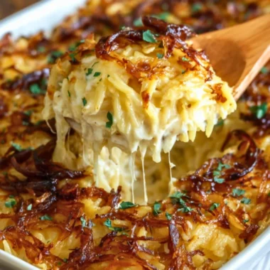 Baked French Onion Chicken Orzo Casserole topped with melted cheese and crispy onions