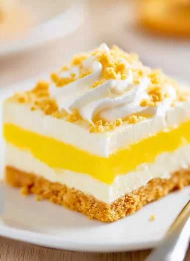 Delicious Heavenly Oreo Lemon Dessert featuring creamy lemon filling and oreo crust.