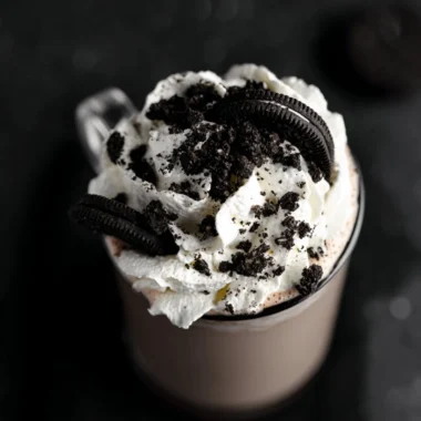 Delicious mug of Oreo Hot Chocolate topped with whipped cream and Oreo crumbs