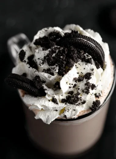 Delicious mug of Oreo Hot Chocolate topped with whipped cream and Oreo crumbs