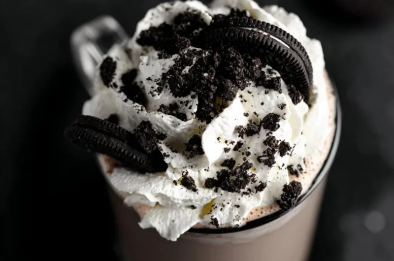 Delicious mug of Oreo Hot Chocolate topped with whipped cream and Oreo crumbs