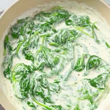Delicious plate of pasta with creamy spinach sauce garnished with herbs