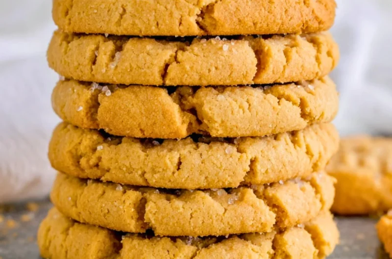 Homemade peanut butter cookies on a plate with a glass of milk