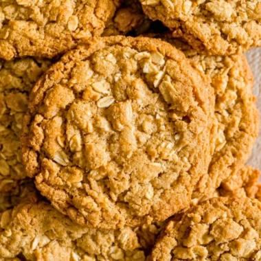 Freshly baked peanut butter oatmeal cookies on a cooling rack.