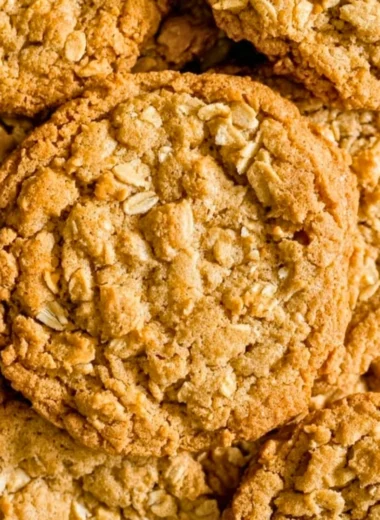 Freshly baked peanut butter oatmeal cookies on a cooling rack.