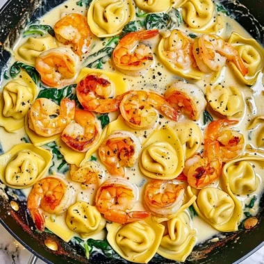 Shrimp tortellini in garlic sauce garnished with parsley on a plate