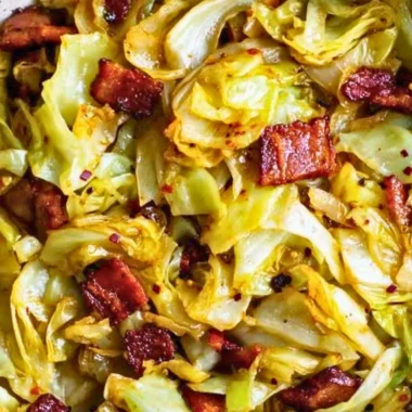 Delicious Southern Fried Cabbage served in a skillet with spices and seasonings.