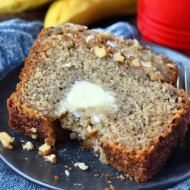 Slice of Starbucks copycat banana bread on a wooden table