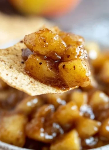 Delicious apple pie dip served in a bowl with cinnamon and apple slices