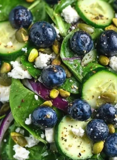 Blueberry pistachio spring salad with fresh greens and vibrant colors