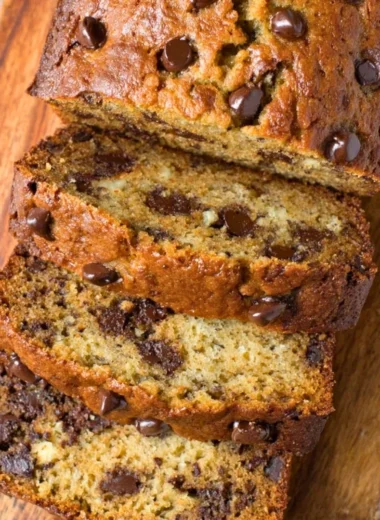 Delicious slice of chocolate chip banana bread on a wooden table