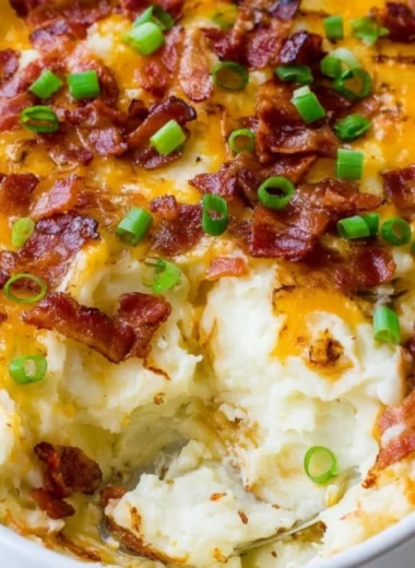 Loaded Mashed Potato Casserole topped with cheese and green onions
