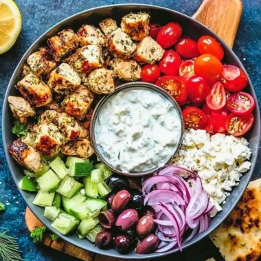 Low-carb keto Greek chicken bowl with fresh vegetables and feta cheese