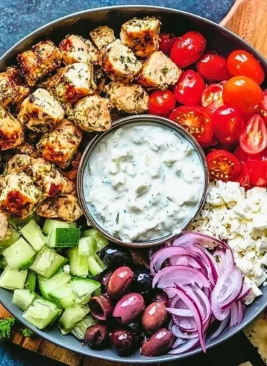 Low-carb keto Greek chicken bowl with fresh vegetables and feta cheese