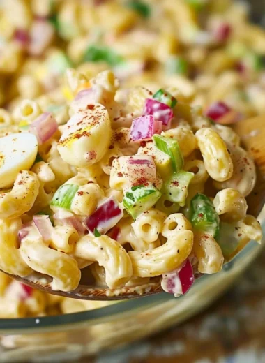 Delicious Southern macaroni salad served in a bowl with fresh ingredients.