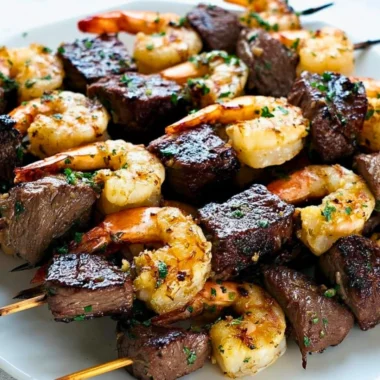 Delicious Surf and Turf Kebabs seasoned and drizzled with chimichurri sauce