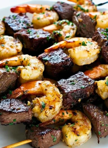 Delicious Surf and Turf Kebabs seasoned and drizzled with chimichurri sauce
