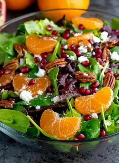 Colorful winter salad with fresh greens, nuts, and seasonal vegetables
