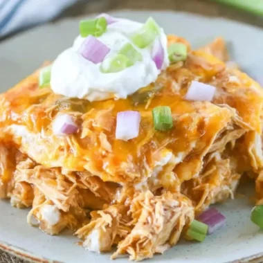 Delicious Chicken Enchilada Casserole topped with cheese and fresh ingredients