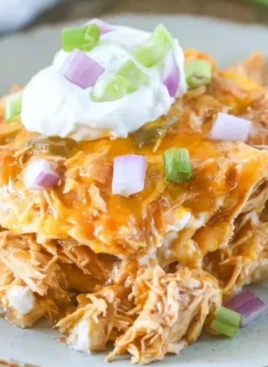 Delicious Chicken Enchilada Casserole topped with cheese and fresh ingredients