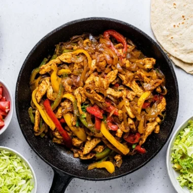 Delicious Chicken Fajitas with peppers and onions served on a plate.